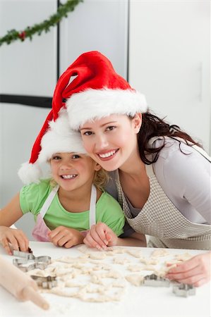 Beautiful mother and daughter cooking Christmas biscuits in the kitchen Stock Photo - Budget Royalty-Free & Subscription, Code: 400-04235233