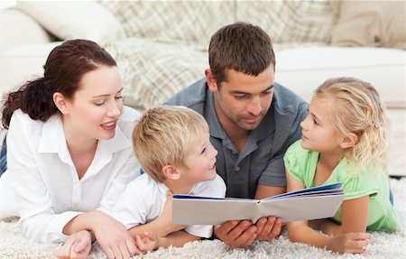 simsearch:400-04193532,k - Family reading a book together lying on the floor at home Stock Photo - Budget Royalty-Free & Subscription, Code: 400-04235254