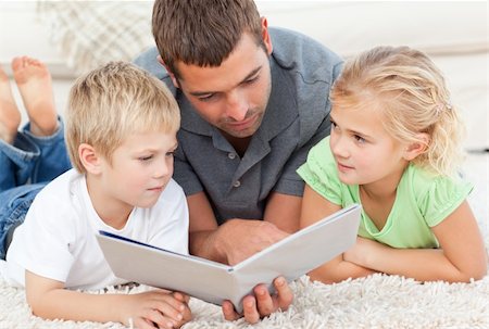 simsearch:400-05751566,k - Father reading book to his children Stock Photo - Budget Royalty-Free & Subscription, Code: 400-04235252