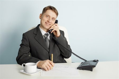 simsearch:400-03989090,k - Smiling businessman in talks on the phone in the office Fotografie stock - Microstock e Abbonamento, Codice: 400-04235317