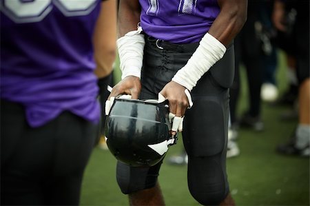natural soft light ,selective focus on hands with football helmet Stock Photo - Budget Royalty-Free & Subscription, Code: 400-04235626