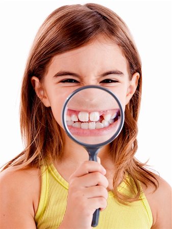 Beautiful girl showing teethes through a magnifying glass Stock Photo - Budget Royalty-Free & Subscription, Code: 400-04236015