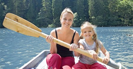 Woman and little girl in a small boat holding the  paddle Stock Photo - Budget Royalty-Free & Subscription, Code: 400-04237039