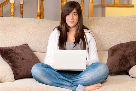 simsearch:400-04017977,k - Young woman with laptop portable computer sitting on sofa Photographie de stock - Aubaine LD & Abonnement, Code: 400-04237184