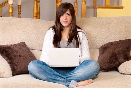 simsearch:400-04017977,k - Young woman with laptop portable computer sitting on sofa Photographie de stock - Aubaine LD & Abonnement, Code: 400-04237186