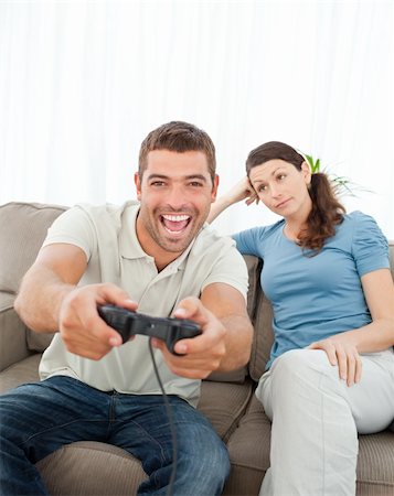 simsearch:400-05297936,k - Bored woman waiting for her boyfriend playing video games Stock Photo - Budget Royalty-Free & Subscription, Code: 400-04237349