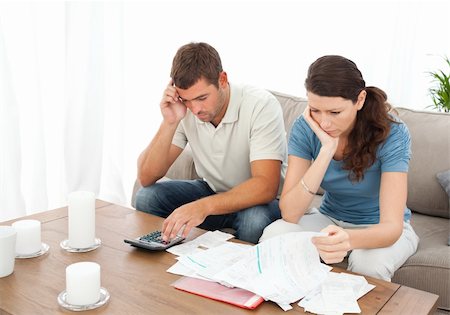 simsearch:400-05746763,k - Desperate couple doing their accounts sitting on the sofa at home Stock Photo - Budget Royalty-Free & Subscription, Code: 400-04237355