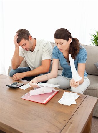 simsearch:400-05746763,k - Worried couple looking at their bills in the living room at home Stock Photo - Budget Royalty-Free & Subscription, Code: 400-04237358