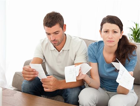 simsearch:400-05746763,k - Desperate woman doing her accounts with her boyfriend sitting on the sofa at home Stock Photo - Budget Royalty-Free & Subscription, Code: 400-04237359