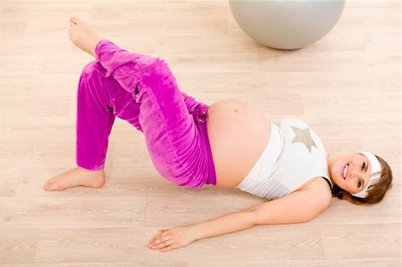 Smiling beautiful pregnant female doing fitness exercises Stock Photo - Budget Royalty-Free & Subscription, Code: 400-04237534