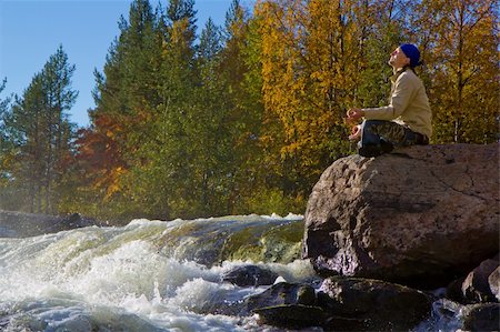 man meditating on a large stone near the waterfall in autumn Stock Photo - Budget Royalty-Free & Subscription, Code: 400-04237810