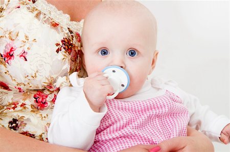 pacifier mom holding - infant with a pacifier in his mother's arms Stock Photo - Budget Royalty-Free & Subscription, Code: 400-04237835