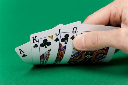 player's hand with the cards on the green game table Stock Photo - Budget Royalty-Free & Subscription, Code: 400-04237842