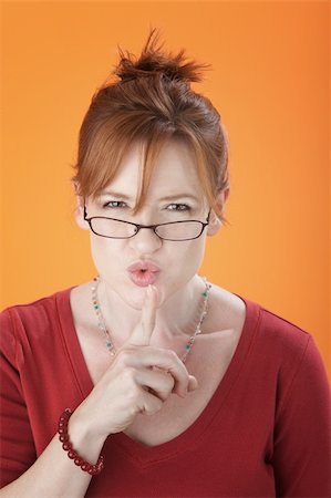 quite - A Middle aged Silencing Woman wearing Spectacles Stock Photo - Budget Royalty-Free & Subscription, Code: 400-04238180