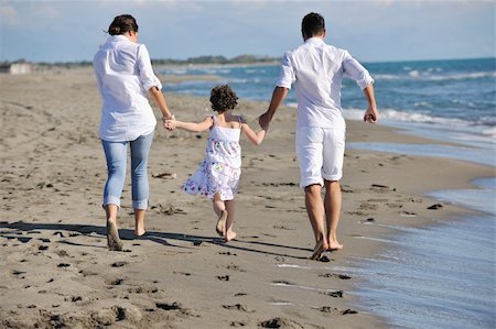 simsearch:400-05291156,k - happy young family in white clothing have fun at vacations on beautiful beach Stock Photo - Budget Royalty-Free & Subscription, Code: 400-04239128