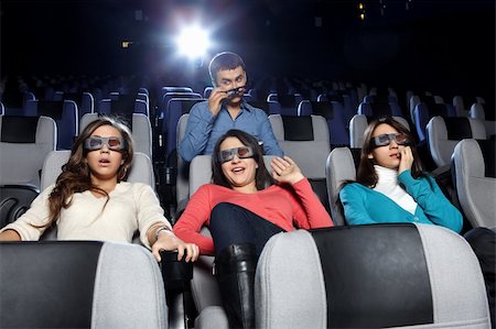 The young man observes of the attractive girl at cinema Stock Photo - Budget Royalty-Free & Subscription, Code: 400-04239296