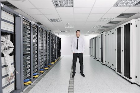 suit on rack - young handsome business man  engeneer in datacenter server room Stock Photo - Budget Royalty-Free & Subscription, Code: 400-04239407