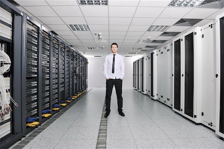 suit on rack - young handsome business man  engeneer in datacenter server room Stock Photo - Budget Royalty-Free & Subscription, Code: 400-04239409
