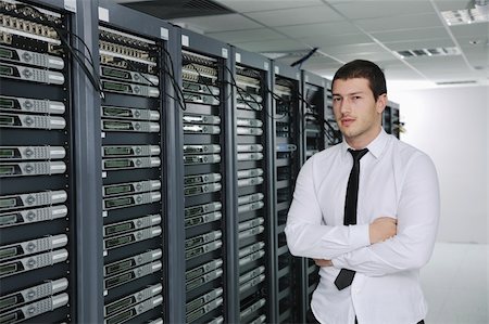 server room managers - young handsome business man  engeneer in datacenter server room Stock Photo - Budget Royalty-Free & Subscription, Code: 400-04239411