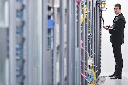 simsearch:400-04239411,k - young engeneer business man with thin modern aluminium laptop in network server room Stock Photo - Budget Royalty-Free & Subscription, Code: 400-04239446