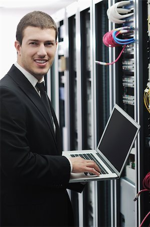 server room managers - young engeneer business man with thin modern aluminium laptop in network server room Stock Photo - Budget Royalty-Free & Subscription, Code: 400-04239448