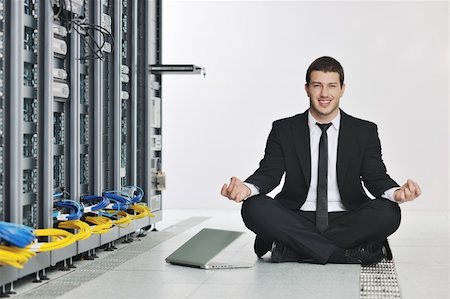 data backup - young handsome business man in black suit and tie practice yoga and relax at network server room while representing stres control concept Stock Photo - Budget Royalty-Free & Subscription, Code: 400-04239454