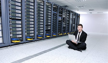 server room managers - young engeneer business man with thin modern aluminium laptop in network server room Stock Photo - Budget Royalty-Free & Subscription, Code: 400-04239450