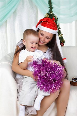 simsearch:400-09222788,k - Mum and son near a christmas fur-tree opens the gift Photographie de stock - Aubaine LD & Abonnement, Code: 400-04239477