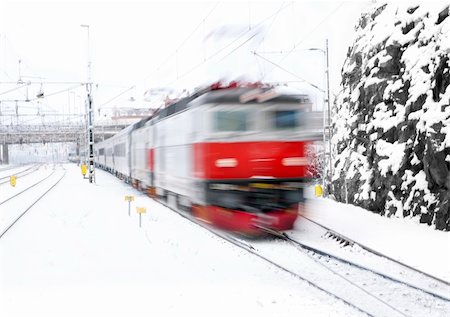 Red train in blurred motion approaching a station Stock Photo - Budget Royalty-Free & Subscription, Code: 400-04239580