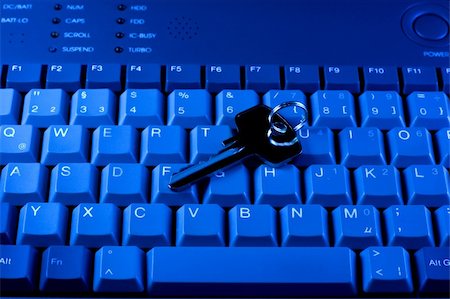 simsearch:400-04698351,k - Key rests upon computer keyboard , blue background Stock Photo - Budget Royalty-Free & Subscription, Code: 400-04230435