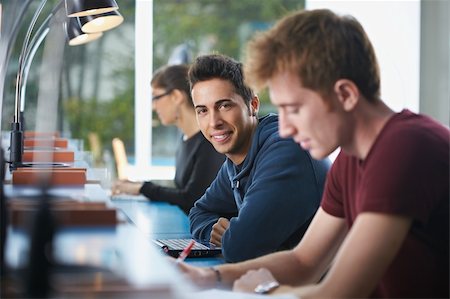 people writing desk lamp - portrait of male college student sitting in library with laptop computer, looking at camera. Horizontal shape, side view, waist up Stock Photo - Budget Royalty-Free & Subscription, Code: 400-04230661