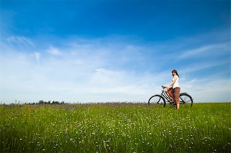 simsearch:400-04201795,k - Happy young woman with a vintage bicycle on a green meadow Stock Photo - Budget Royalty-Free & Subscription, Code: 400-04230816