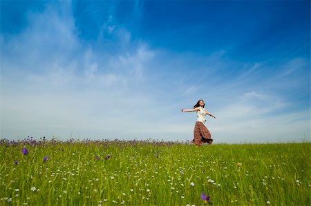 Young woman dancing on a beautiful green meadow Stock Photo - Budget Royalty-Free & Subscription, Code: 400-04230818