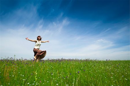 Young woman dancing on a beautiful green meadow Stock Photo - Budget Royalty-Free & Subscription, Code: 400-04230819