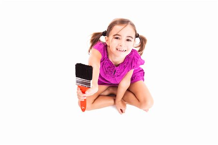 Top view of a happy girl sitting on floor holding a paint-brush Stock Photo - Budget Royalty-Free & Subscription, Code: 400-04230861