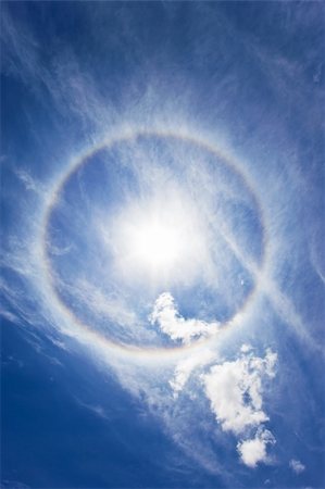 simsearch:400-05159767,k - Sun with circular rainbow - sun halo occurring due to ice crystals in atmosphere Stock Photo - Budget Royalty-Free & Subscription, Code: 400-04231076