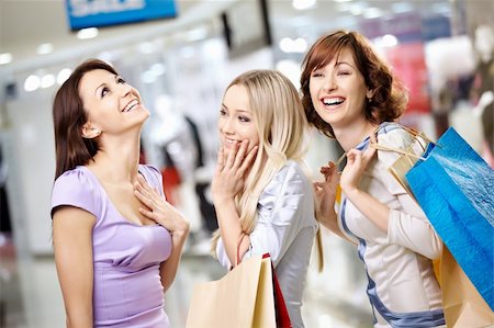 Happy smiling girls in shop with purchases Stock Photo - Budget Royalty-Free & Subscription, Code: 400-04231344