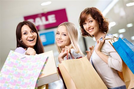 Happy smiling girls in shop with purchases Stock Photo - Budget Royalty-Free & Subscription, Code: 400-04231343