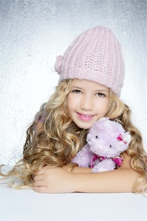 small little girl pic to hug a teddy - winter fashion cap little girl hug teddy bear smiling silver background Stock Photo - Budget Royalty-Free & Subscription, Code: 400-04231371