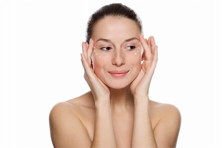 Beautiful sexy woman applying cosmetic cream on skin near eyes. Isolated on white background Fotografie stock - Microstock e Abbonamento, Codice: 400-04231915