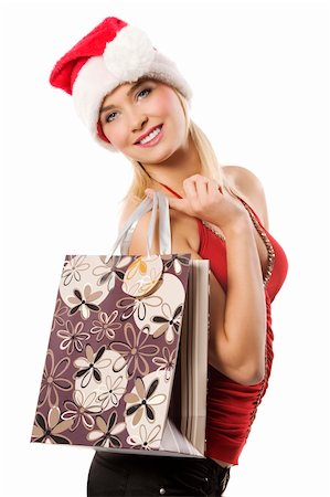 simsearch:400-06477682,k - blond and cute woman with a christmas hat and a shopping bag looking in camera smiling Stock Photo - Budget Royalty-Free & Subscription, Code: 400-04232165