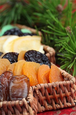 Christmas tree basket with dried fruits on red background. Shallow dof Stock Photo - Budget Royalty-Free & Subscription, Code: 400-04232388