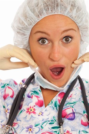 doctor with cap and mask - Humorous close-up portrait of young nurse with mask and cap Stock Photo - Budget Royalty-Free & Subscription, Code: 400-04232457