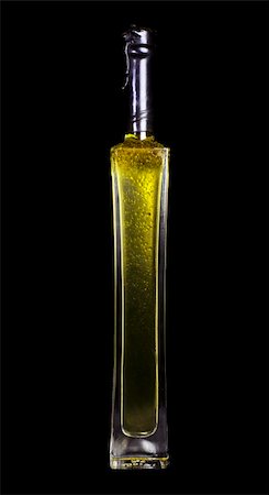 simsearch:622-07743615,k - A bottle of extra virgin olive oil isolated on black Stock Photo - Budget Royalty-Free & Subscription, Code: 400-04233205