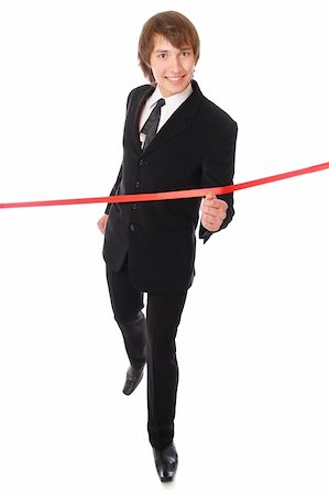 teenage businessman is running through the red line. Isolated at white background Stock Photo - Budget Royalty-Free & Subscription, Code: 400-04233343