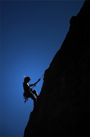 A climber hangs from a thread on the side of a cliff. Stock Photo - Budget Royalty-Free & Subscription, Code: 400-04233733
