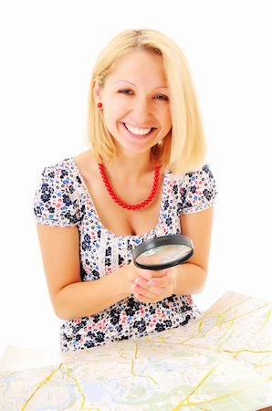 Beautiful young smiling girl with magnifying glass and map over white background Stock Photo - Budget Royalty-Free & Subscription, Code: 400-04240081