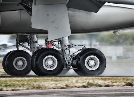 Landing gears of a wide body aircraft landing on a wet runway Stock Photo - Budget Royalty-Free & Subscription, Code: 400-04240107