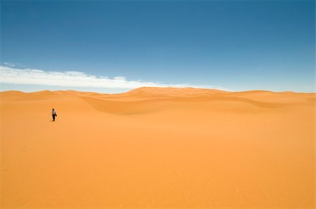 simsearch:400-04034980,k - Woman walking alone among the sand dunes of the Sahara desert. Best of Morocco. Foto de stock - Royalty-Free Super Valor e Assinatura, Número: 400-04240489