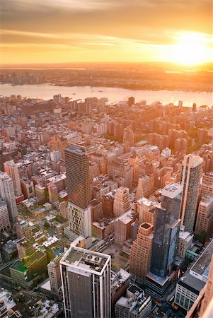 simsearch:400-04240640,k - New York City Manhattan sunset skyline aerial view with office building skyscrapers and Hudson River. Fotografie stock - Microstock e Abbonamento, Codice: 400-04240581